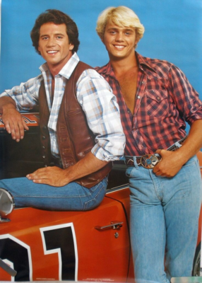 Late 1970's or early 1980's poster that shows Bo And Luke Duke standing together next to the General Lee. Characters from the Dukes of Hazzard TV Show. 
